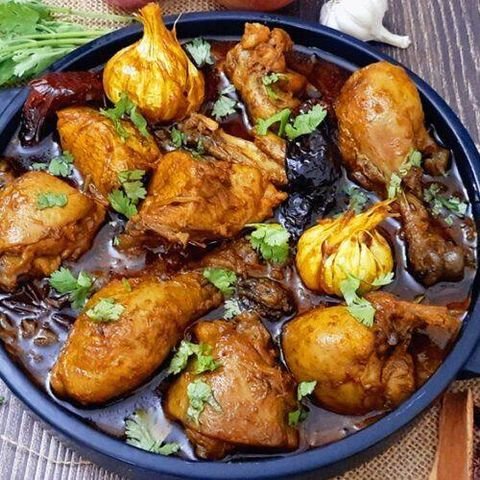 Chicken cooked with whole garlic bulbs and dried red chillies